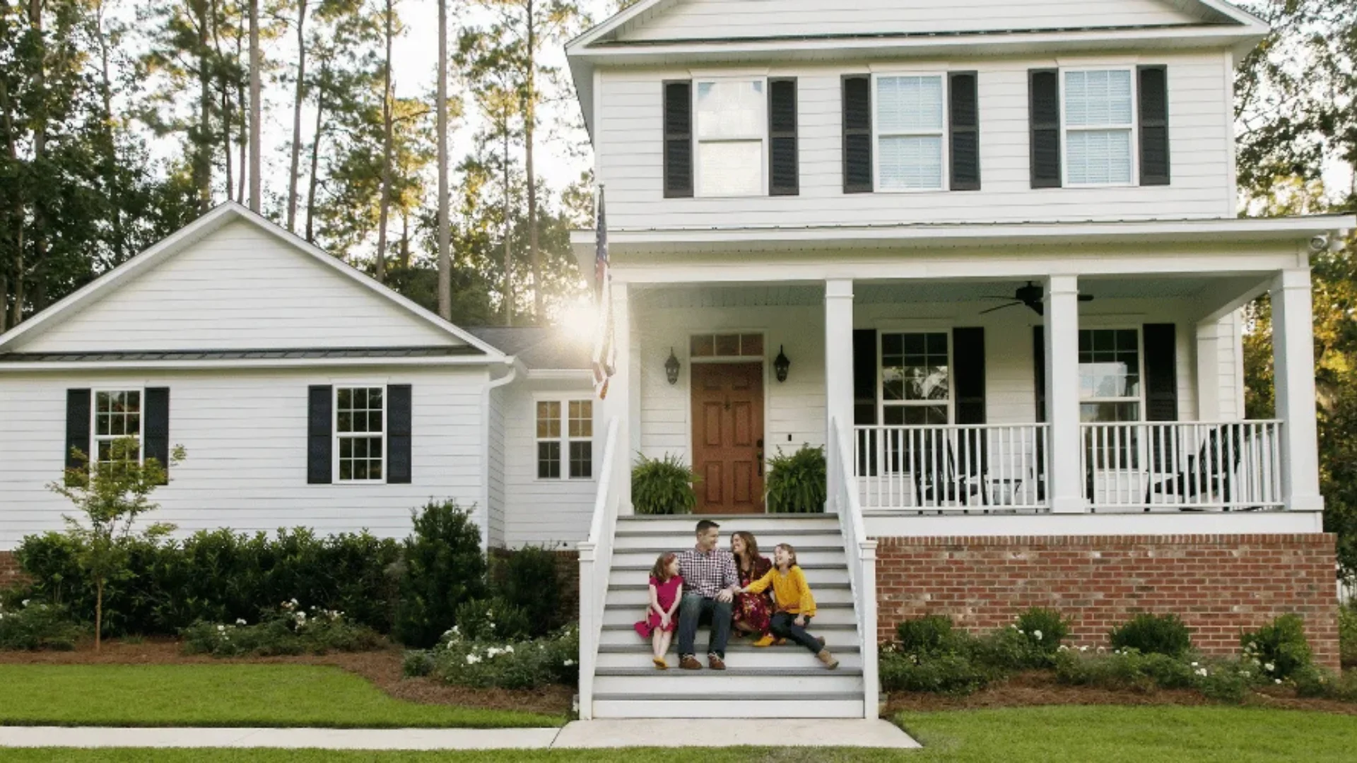Family on the front steps of their home in Rochester, NY