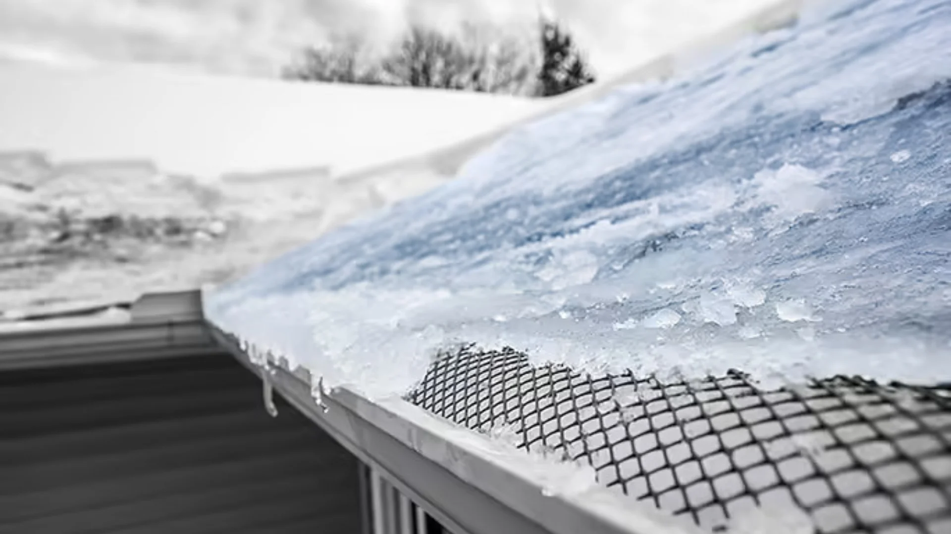 Ice dam and icicles along a roof eave in Rochester, NY