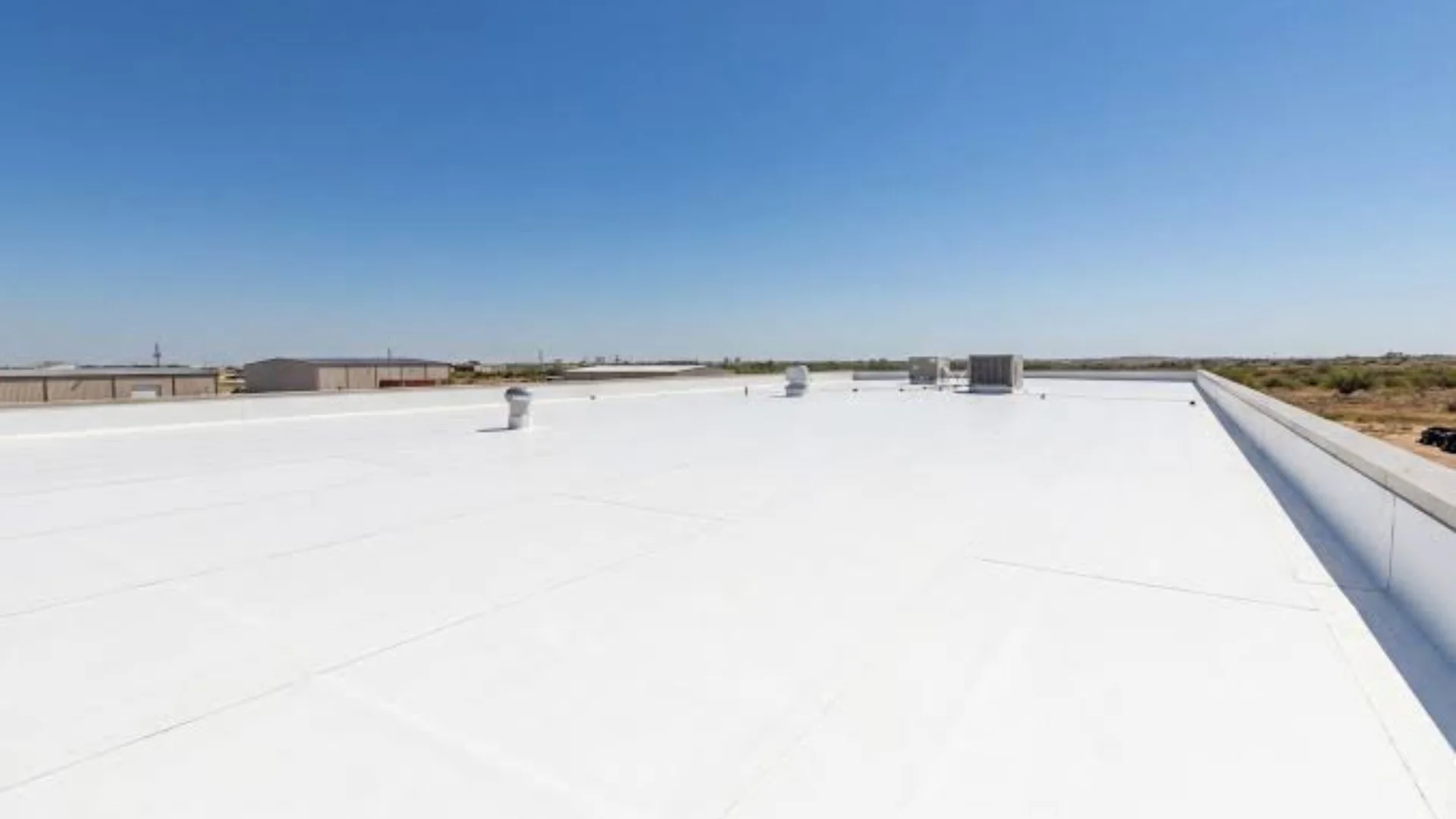 White TPO membrane installed on a flat roof in Rochester, NY
